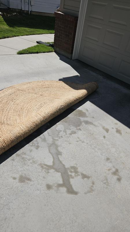 Customer photo for review titled "Rug came wrapped in plastic holding moisture"