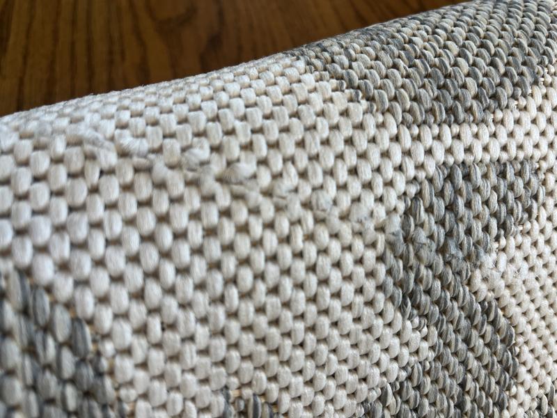 Customer photo for review titled "Received 2 damaged rugs"