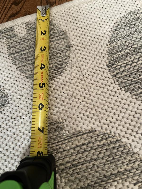 Customer photo for review titled "Received 2 damaged rugs"