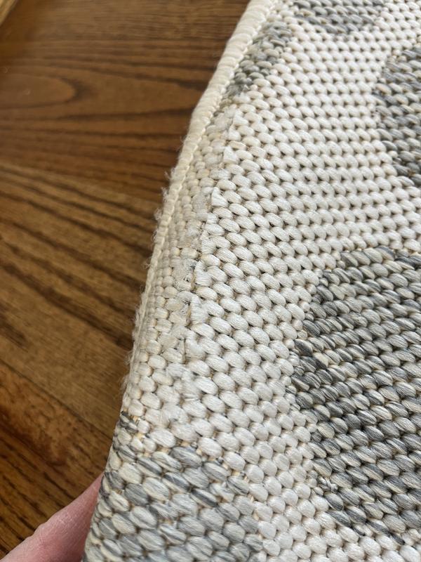 Customer photo for review titled "Received 2 damaged rugs"