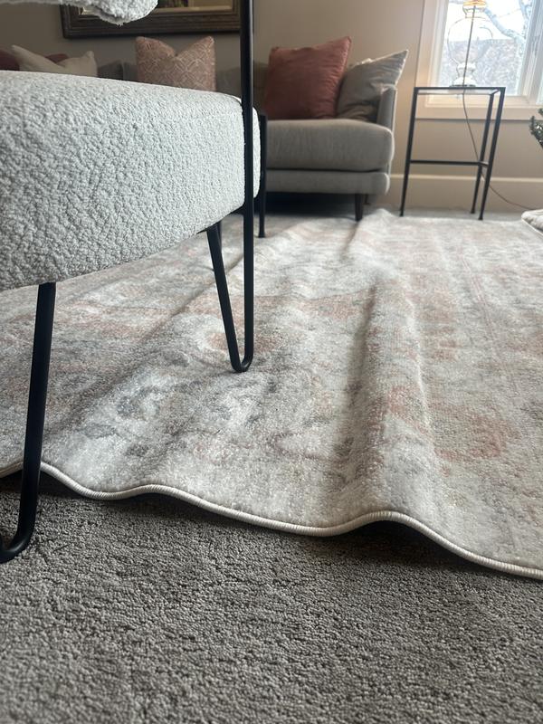Customer photo for review titled "Horrible folds in rug. Looks cheap and tacky"