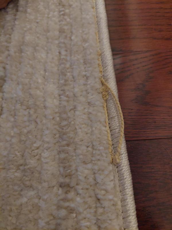 Customer photo for review titled "The rug arrived with defect it is unstitched....."