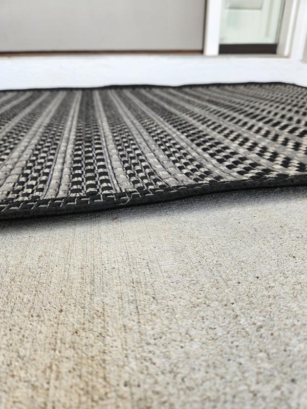 Customer photo for review titled "Rugs curls up on edges- tripping hazard"