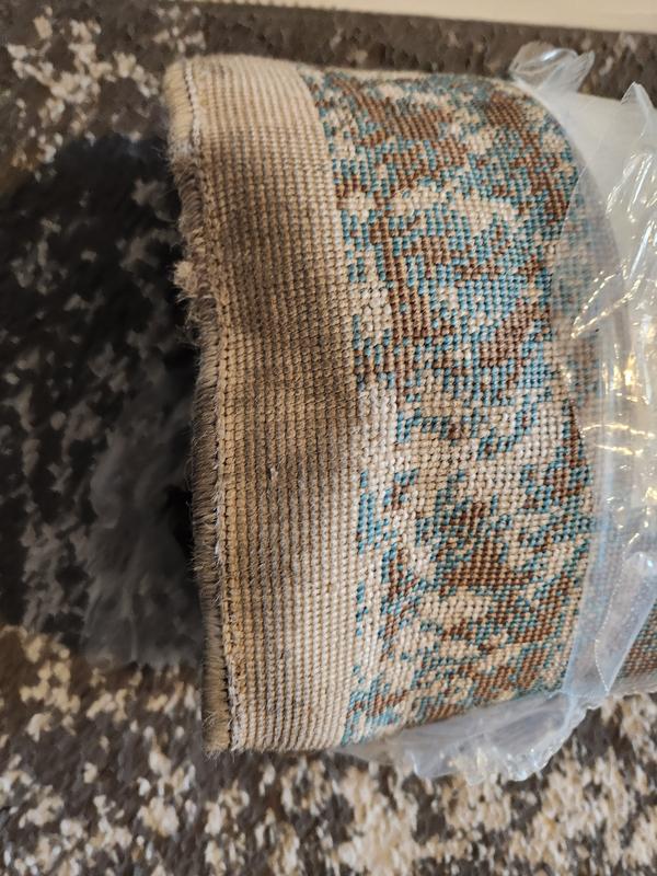 Customer photo for review titled "Nice rug but quality is poor."